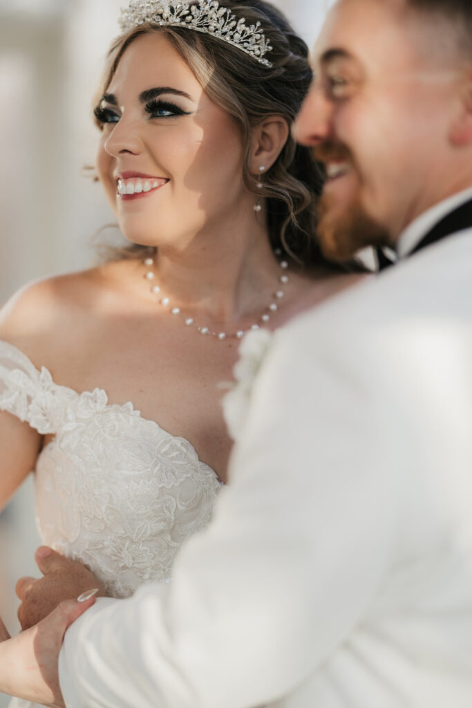 couple takes bride and groom portraits at the glass chapel