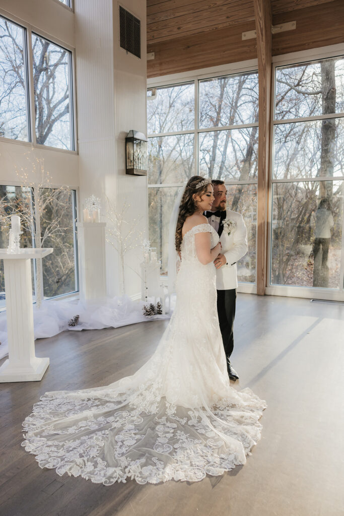 couple takes bride and groom portraits at the glass chapel