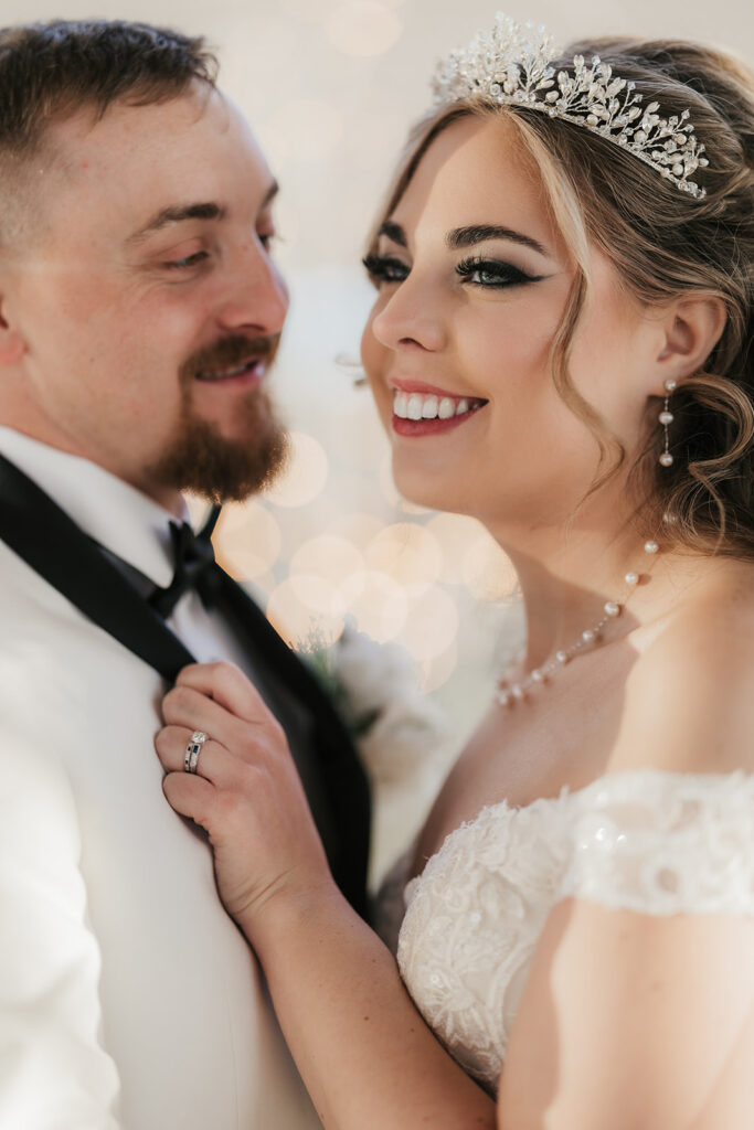 couple takes bride and groom portraits at the glass chapel