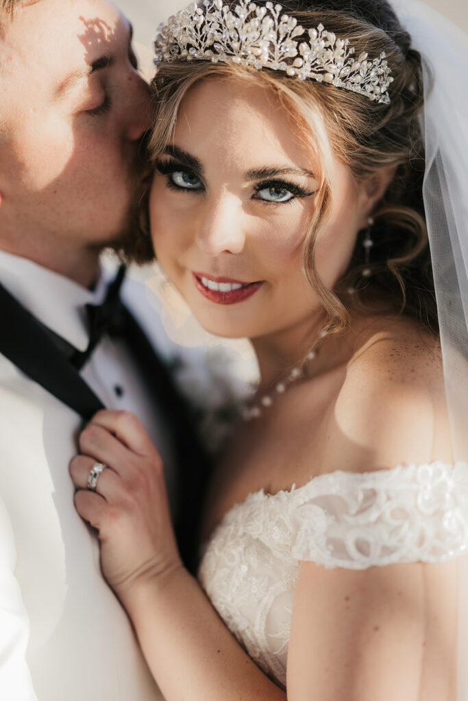 couple takes bride and groom portraits at the glass chapel