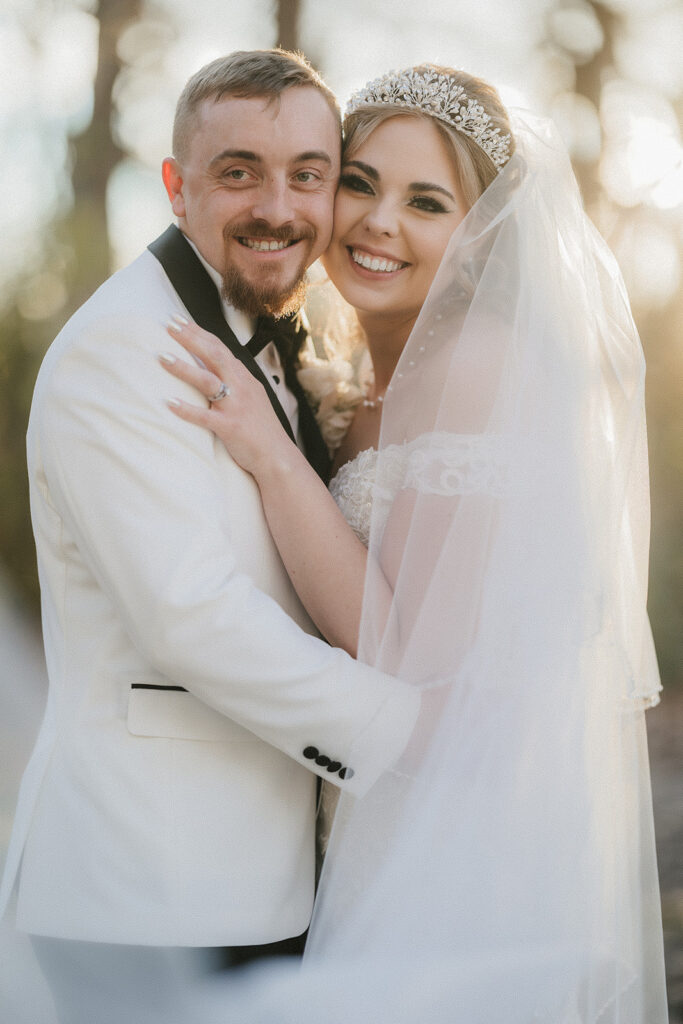 couple takes bride and groom portraits at the glass chapel