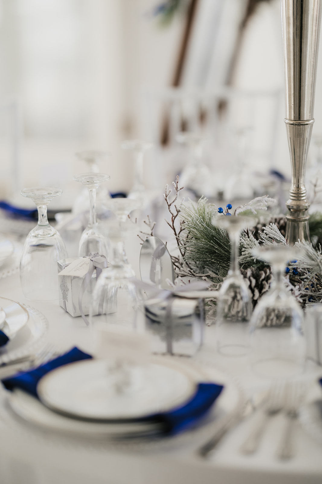 A winter-themed wedding table centerpiece at glass chapel