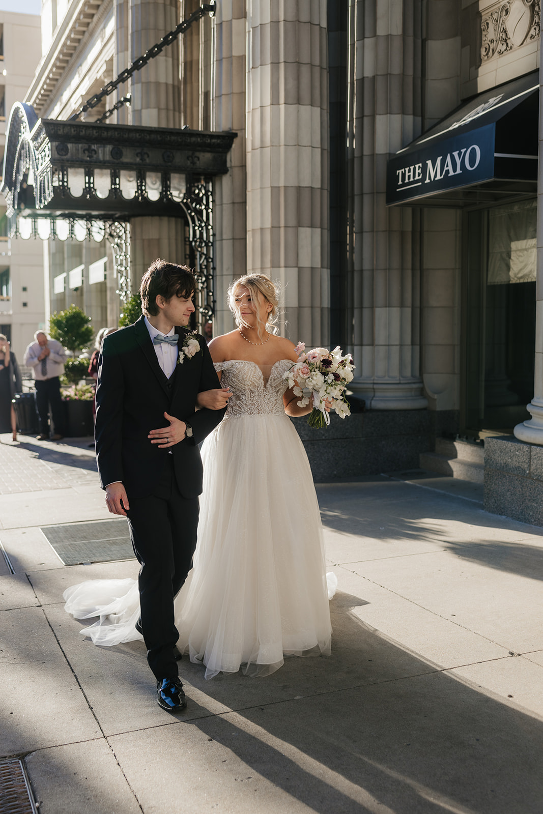 bride and groom take wedding portraits for their wedding at the Mayo Hotel