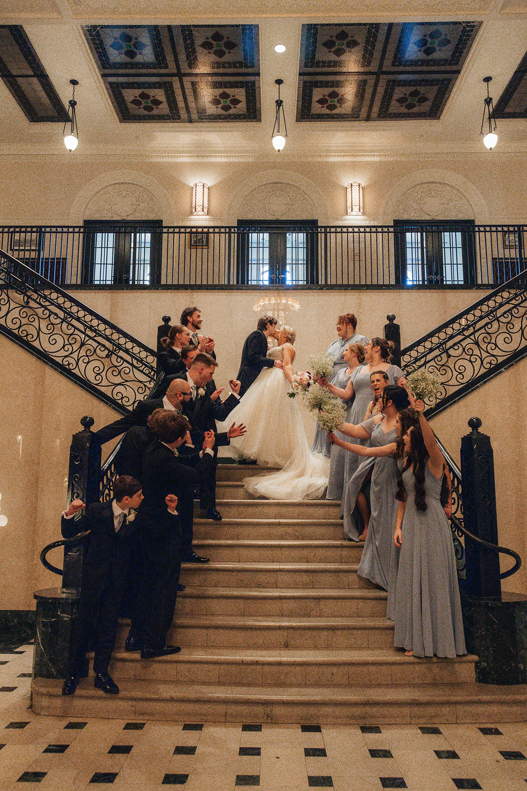 bride and groom take wedding party portraits outside the cathedral