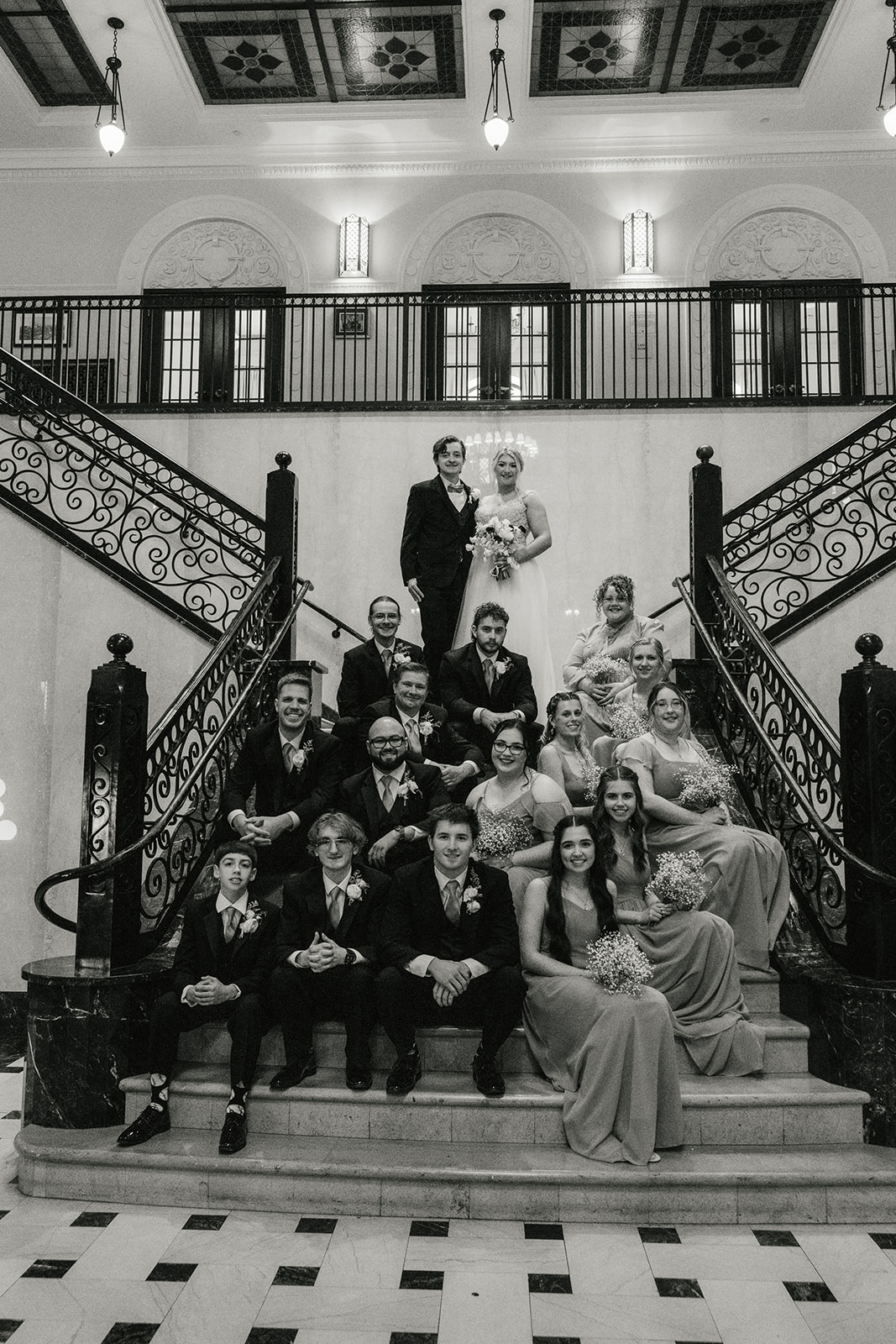 bride and groom take wedding party portraits outside the cathedral