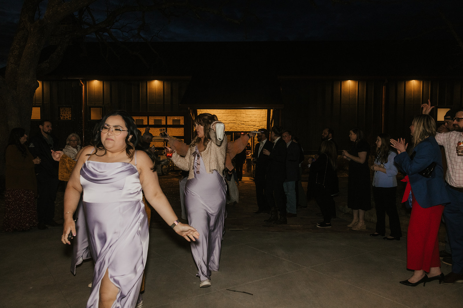 people dance on the dance floor outdoors at a wedding