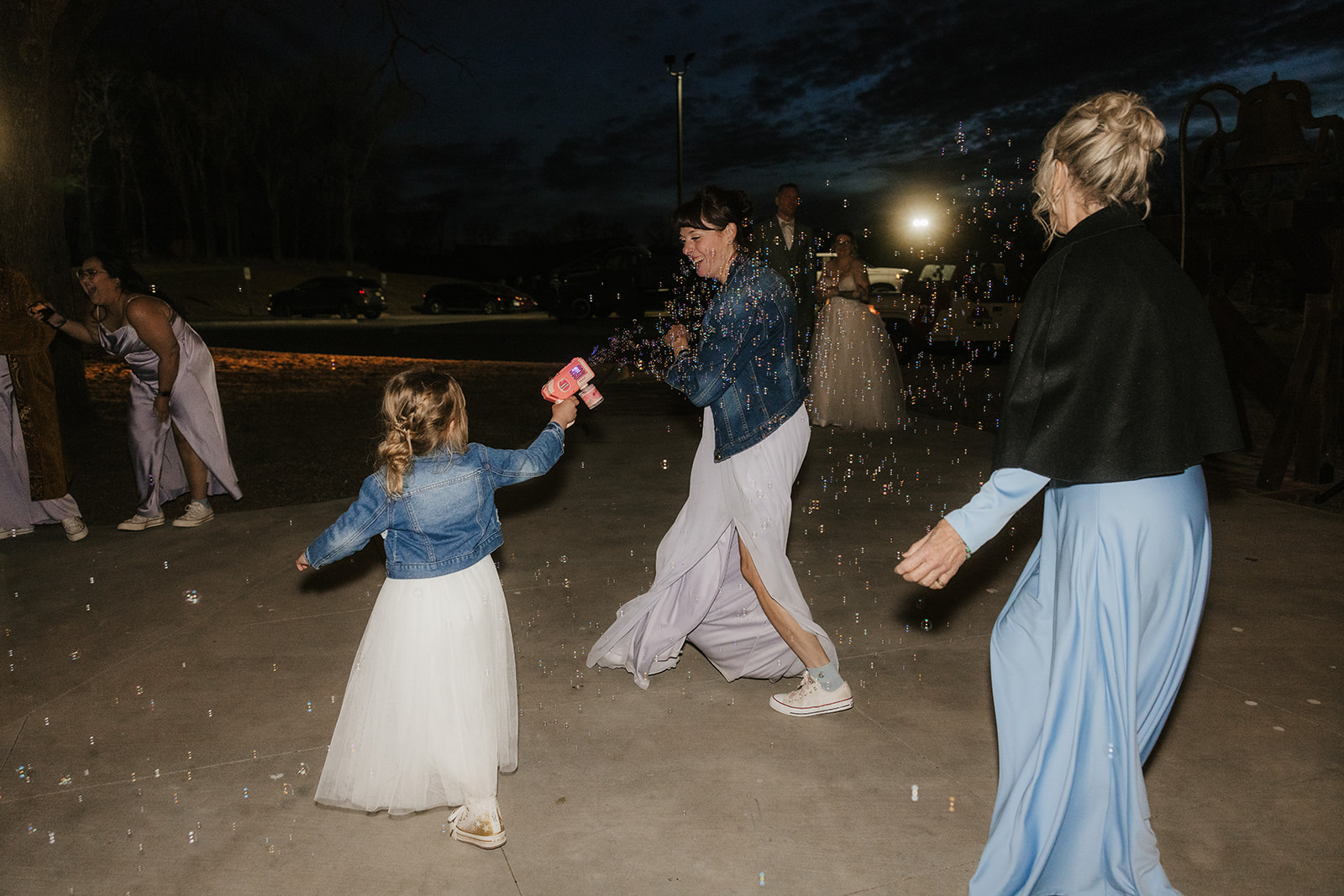 people dance on the dance floor outdoors at a wedding