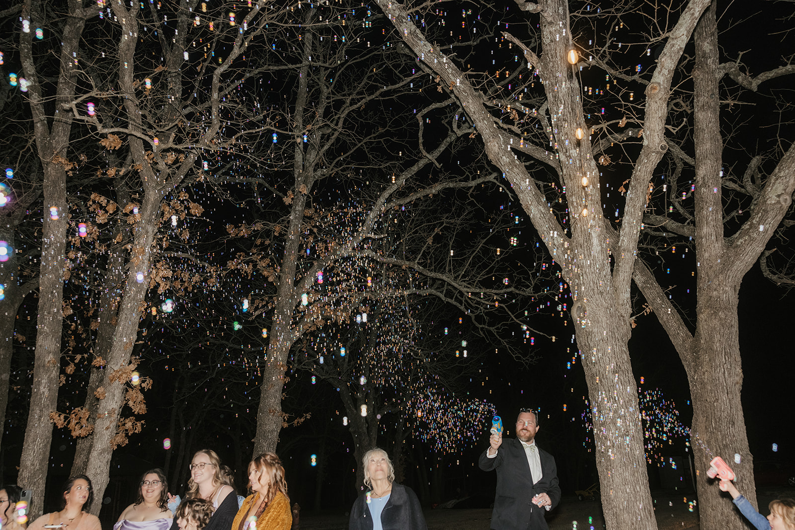 people dance on the dance floor outdoors at a wedding