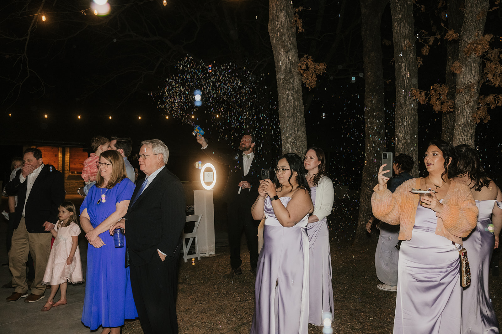 people dance on the dance floor outdoors at a wedding