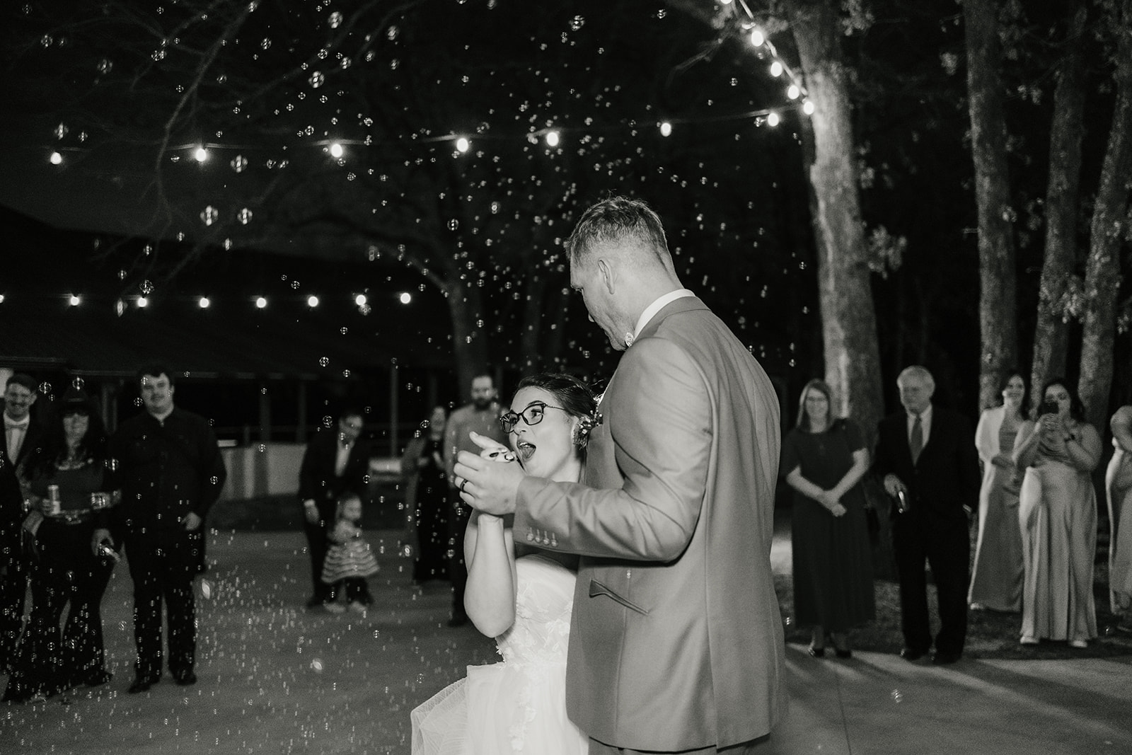 people dance on the dance floor outdoors at a wedding