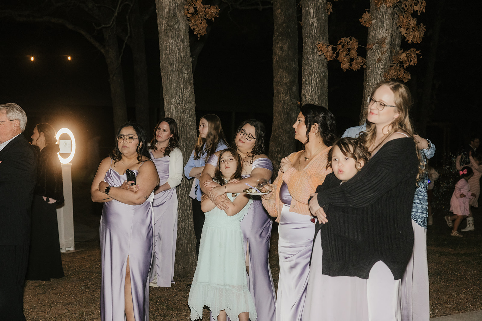 people dance on the dance floor outdoors at a wedding