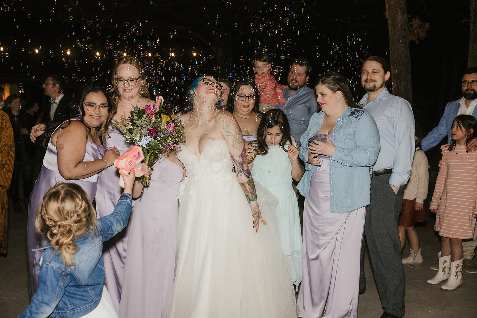 people dance on the dance floor outdoors at a wedding