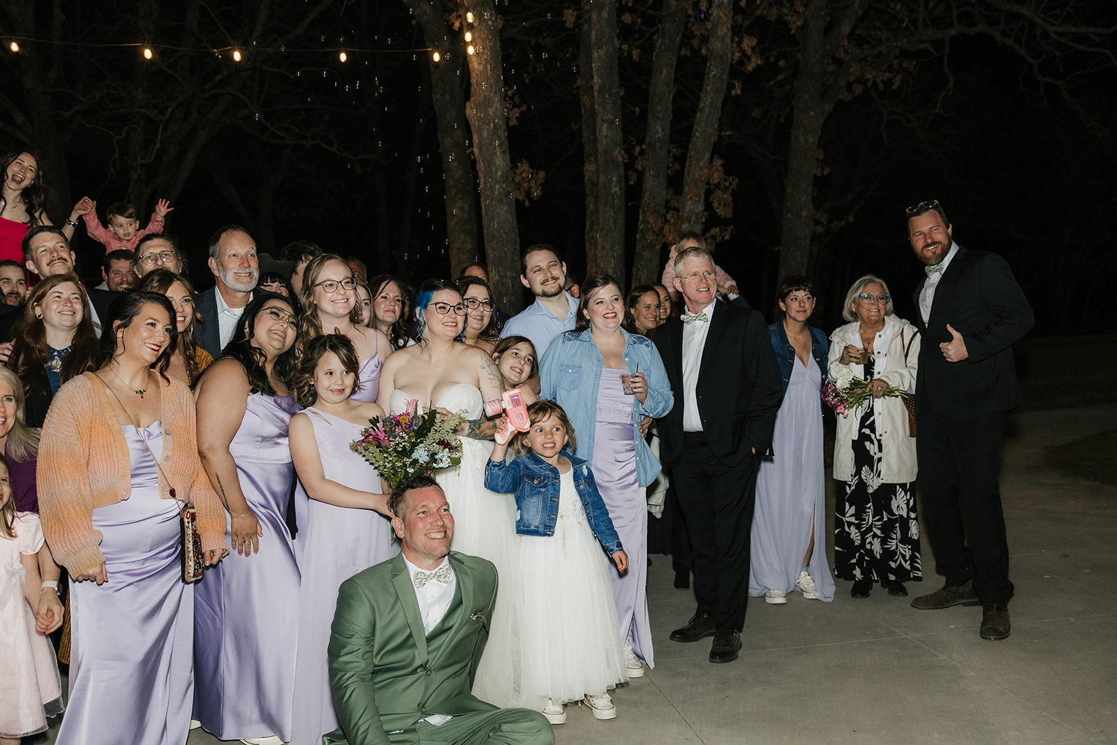 people dance on the dance floor outdoors at a wedding