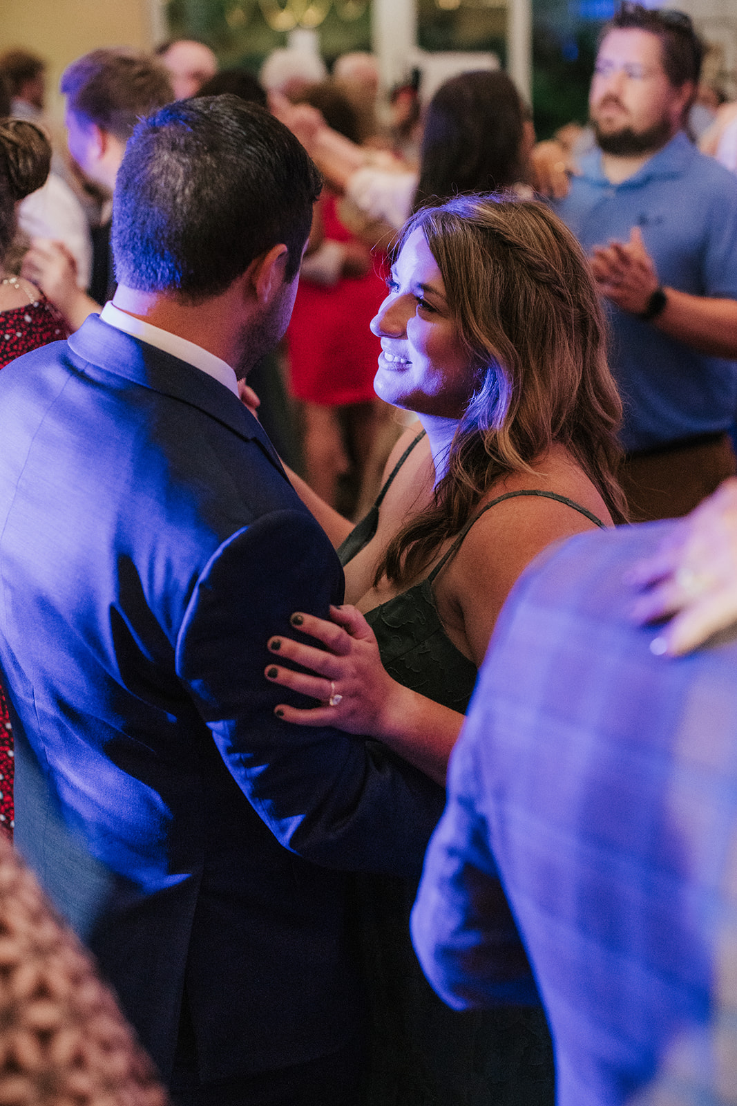 people dancing on the dance floor for a fun wedding at spain ranch