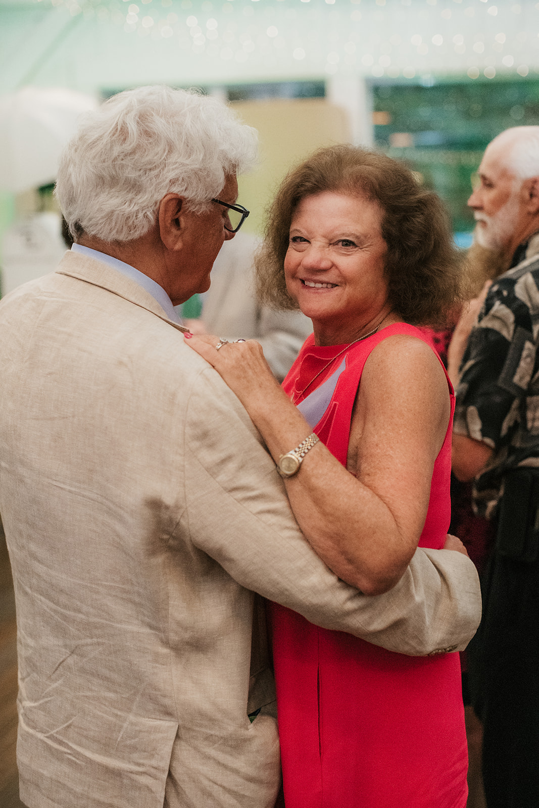 people dancing on the dance floor for a fun wedding at spain ranch