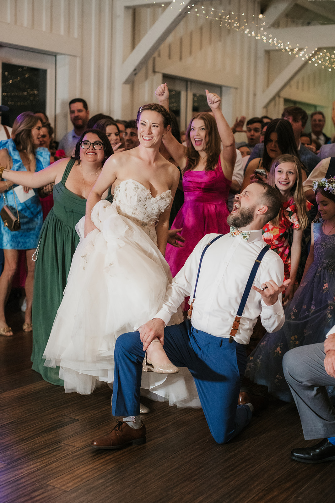 people dancing on the dance floor for a fun wedding at spain ranch