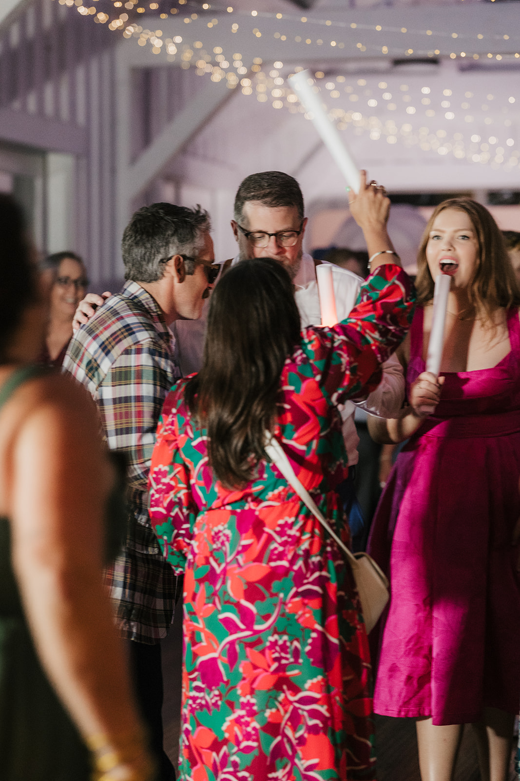 people dancing on the dance floor for a fun wedding at spain ranch
