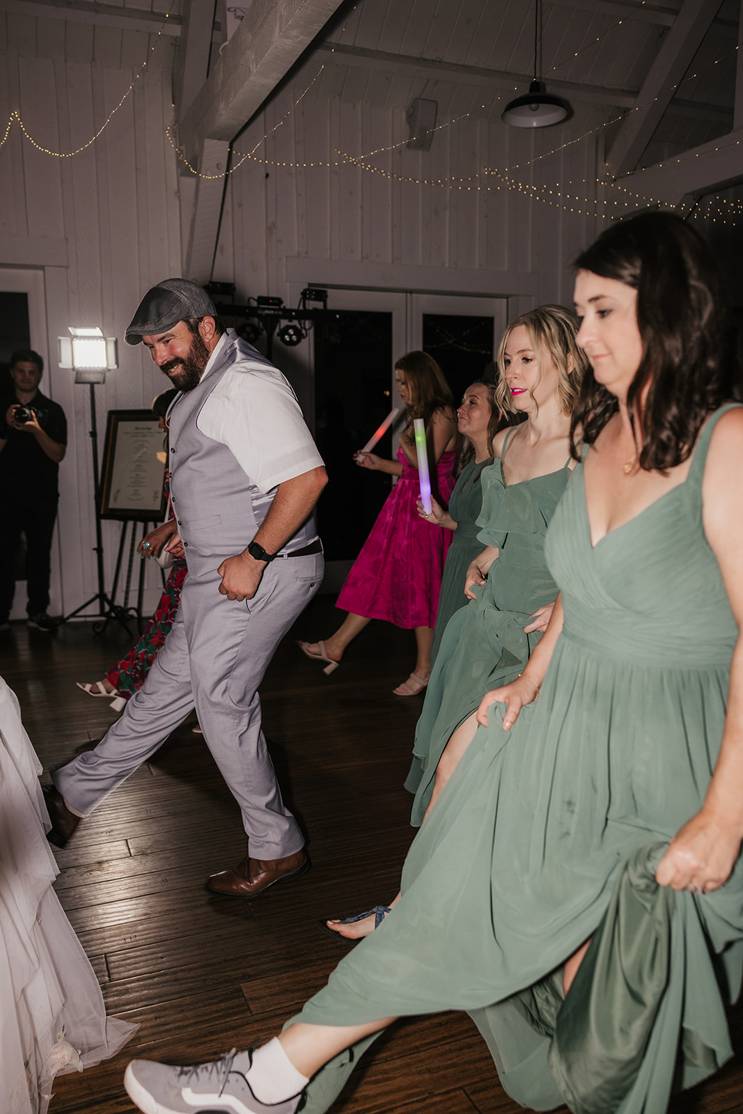people dancing on the dance floor for a fun wedding at spain ranch