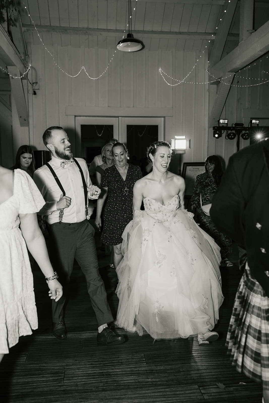 people dancing on the dance floor for a fun wedding at spain ranch