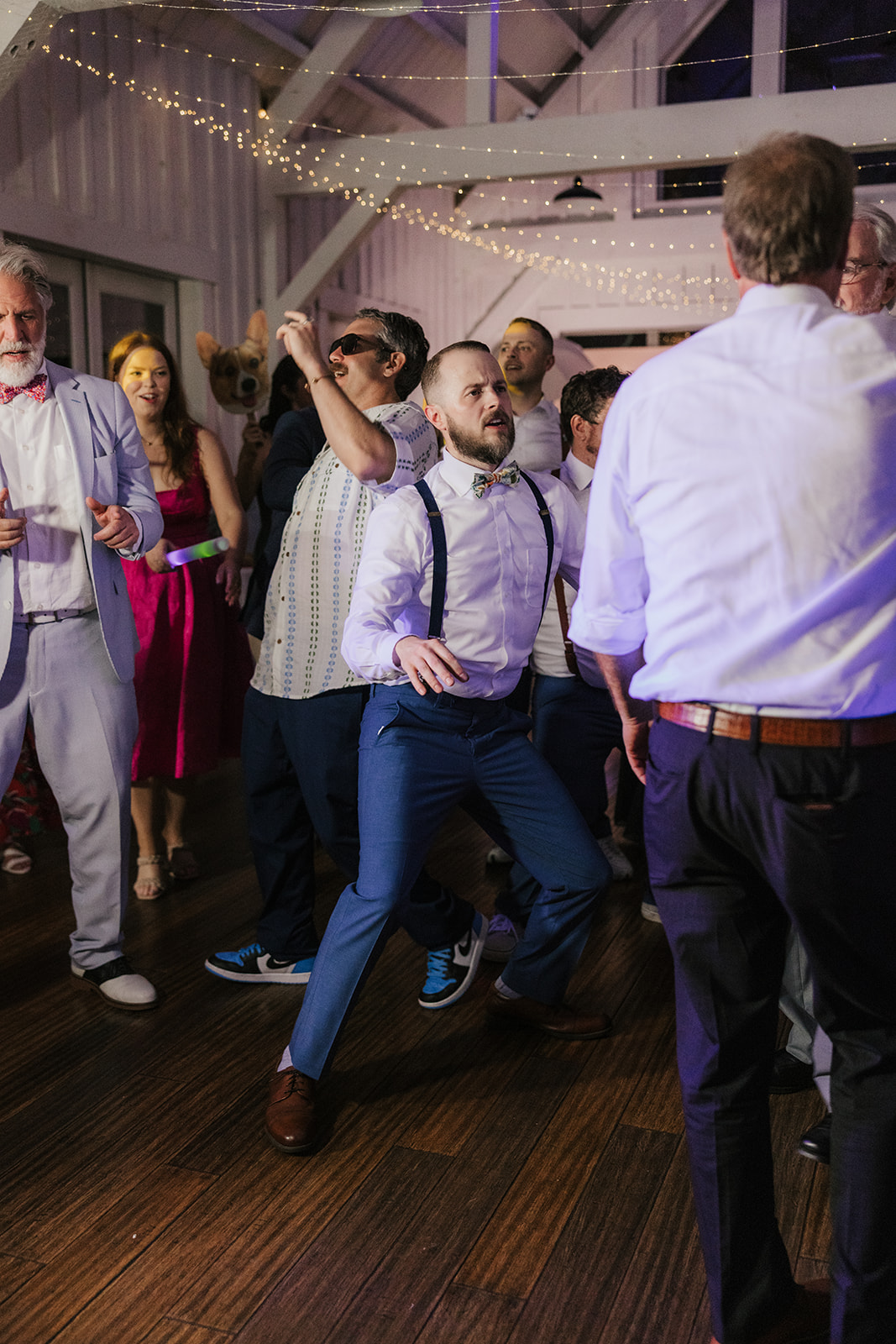 people dancing on the dance floor for a fun wedding at spain ranch