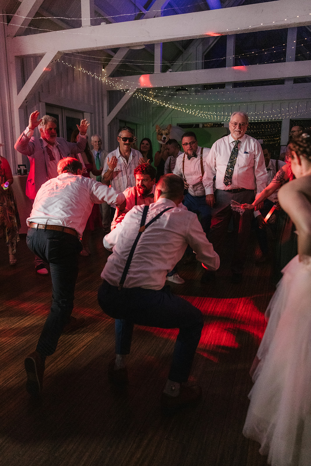 people dancing on the dance floor for a fun wedding at spain ranch