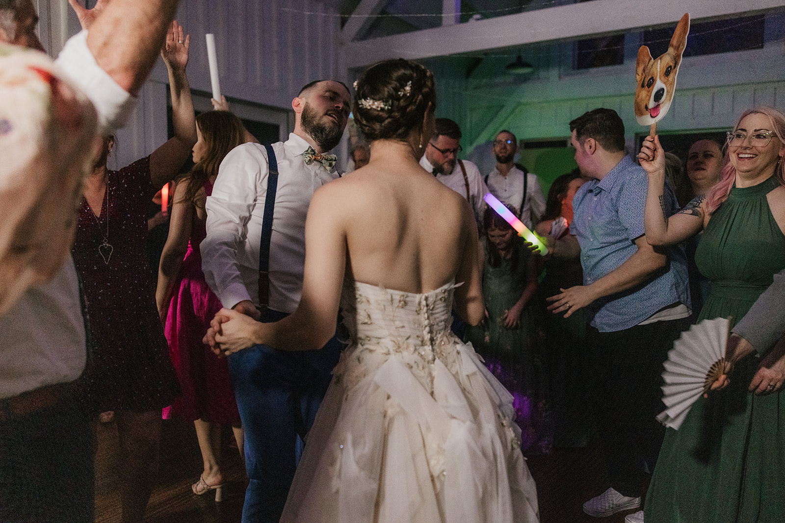 people dancing on the dance floor for a fun wedding at spain ranch