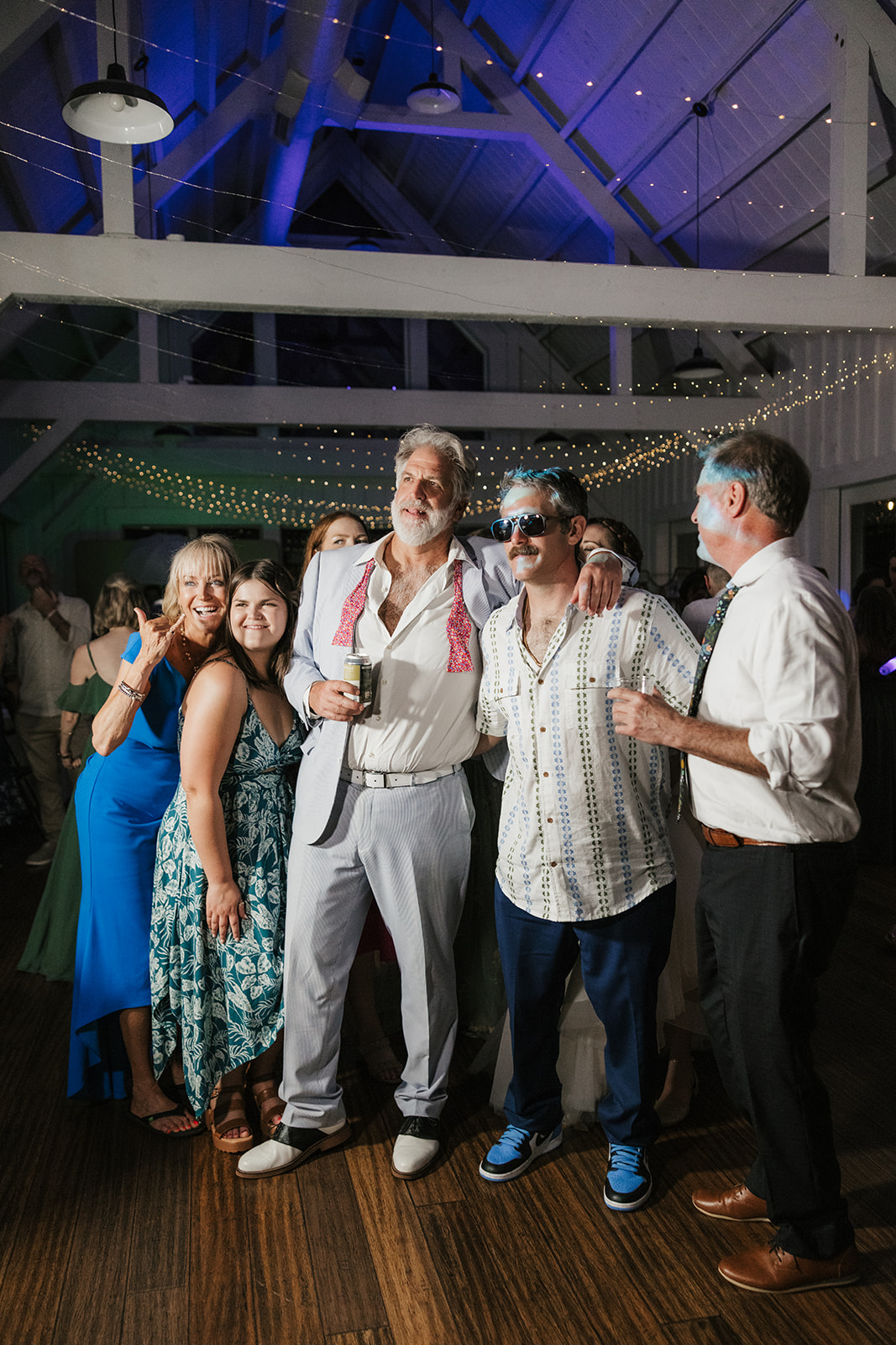 people dancing on the dance floor for a fun wedding at spain ranch