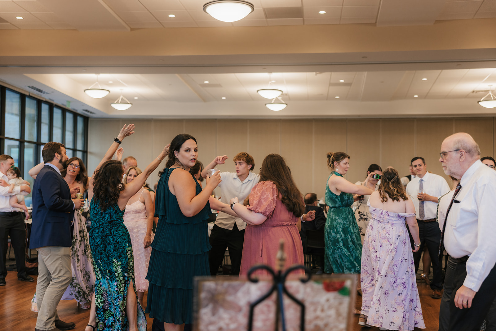 people dancing on the dance floor at a celebration