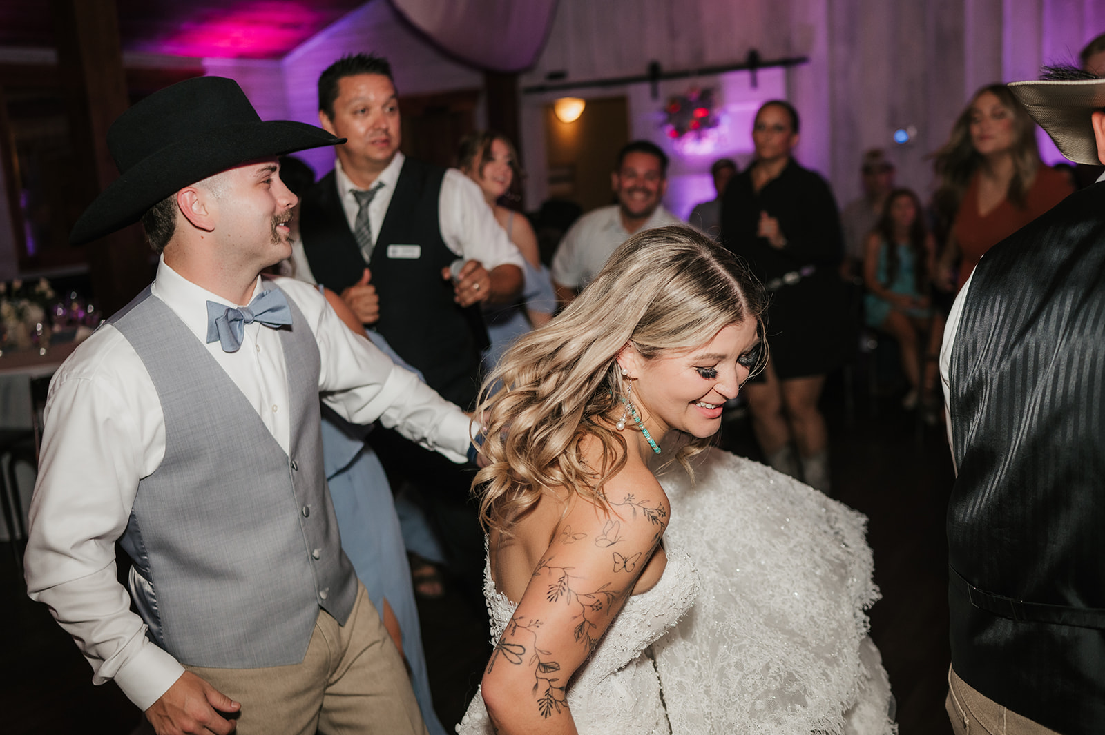a group of people dancing at a wedding