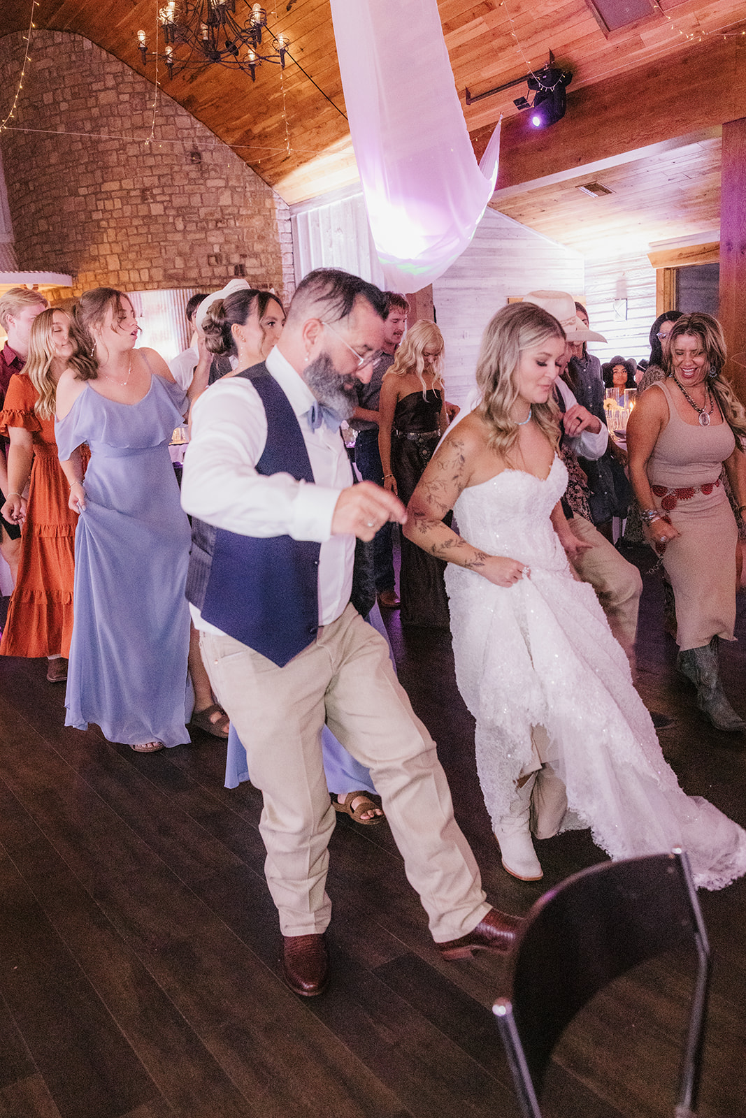 a group of people dancing at a wedding