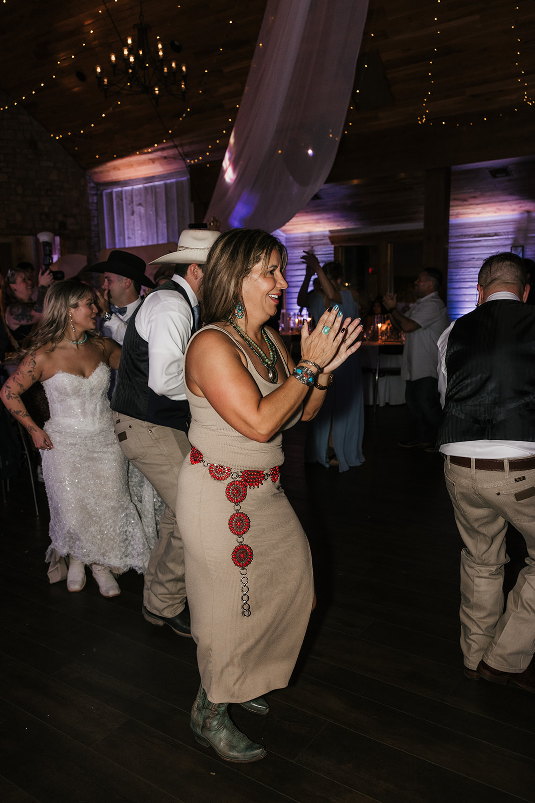a group of people dancing at a wedding