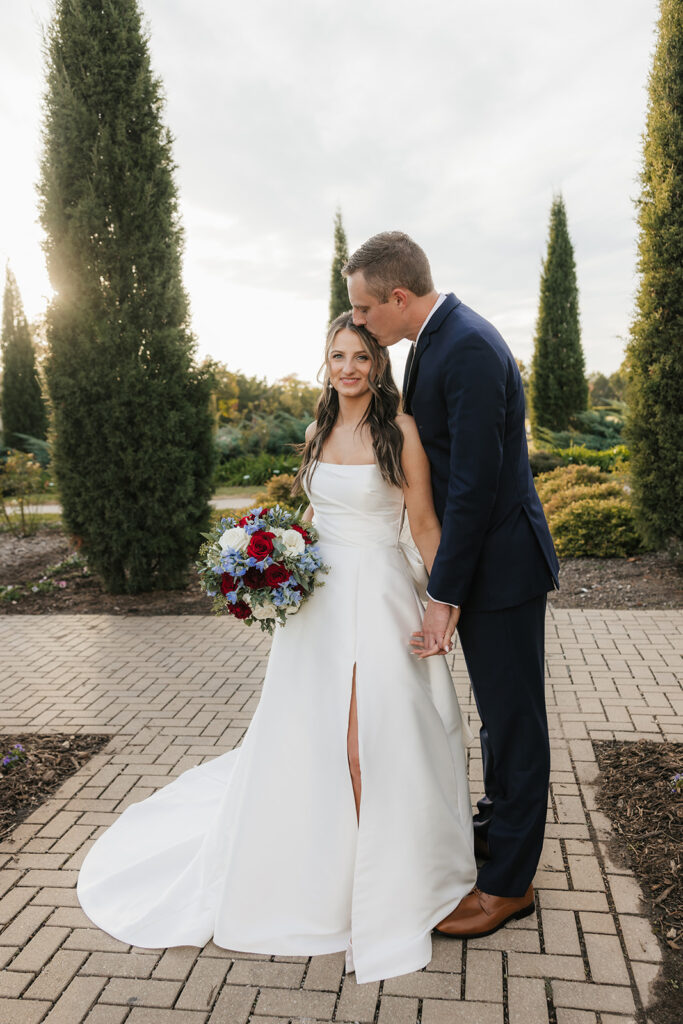 groom kissing the bride on the forehead