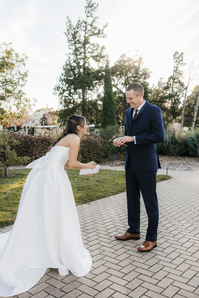 bride and groom reading their vows