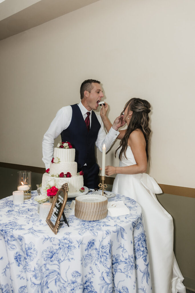 bride and groom trying their wedding cake