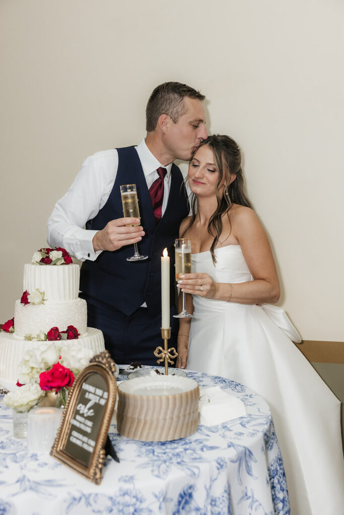 groom kissing the bride on the forehead