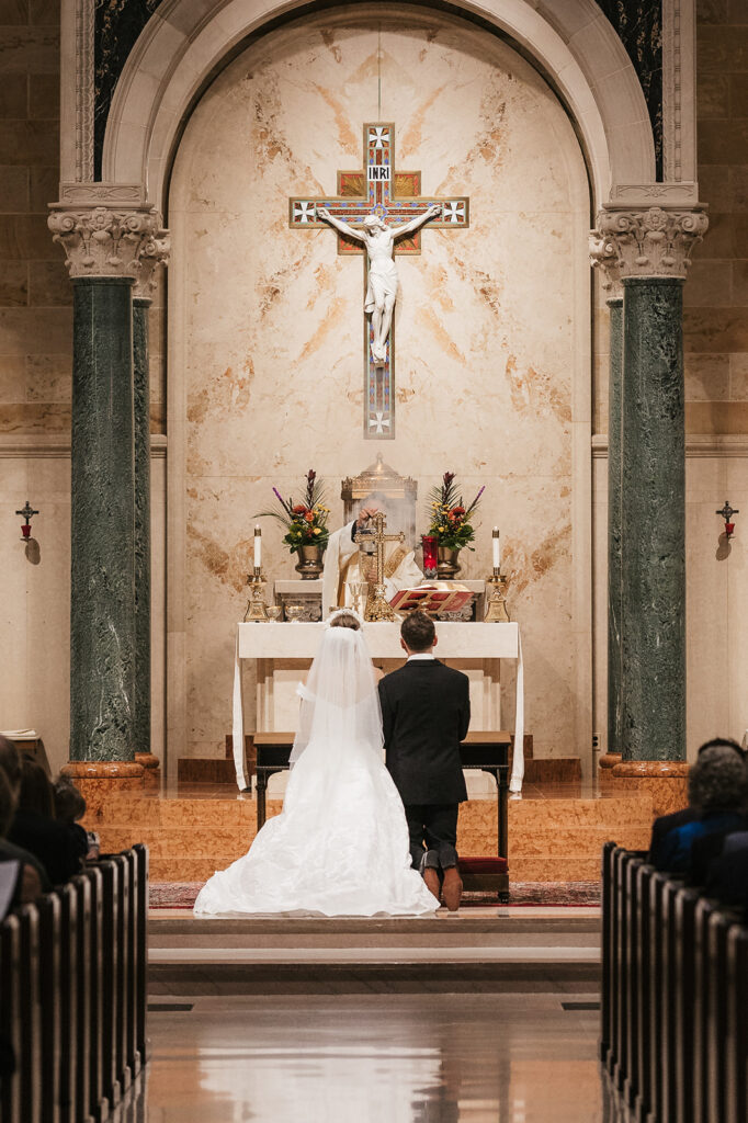 cute picture of the bride and groom holding hands during their wedding ceremony