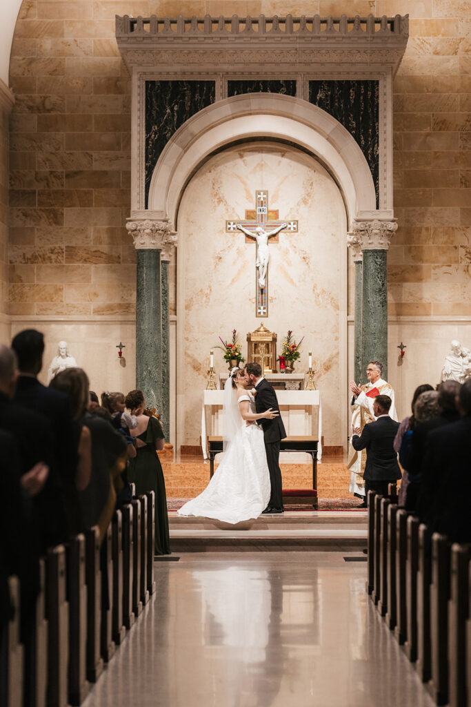 cute picture of the newlyweds kissing after the ceremony