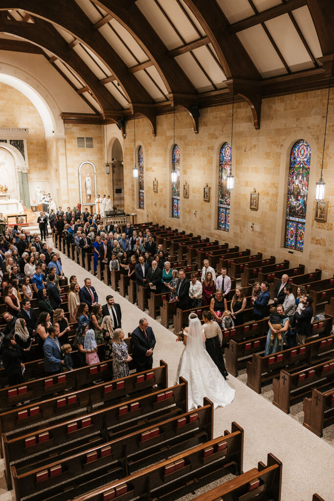 stunning portrait of the bride walking down the aisle