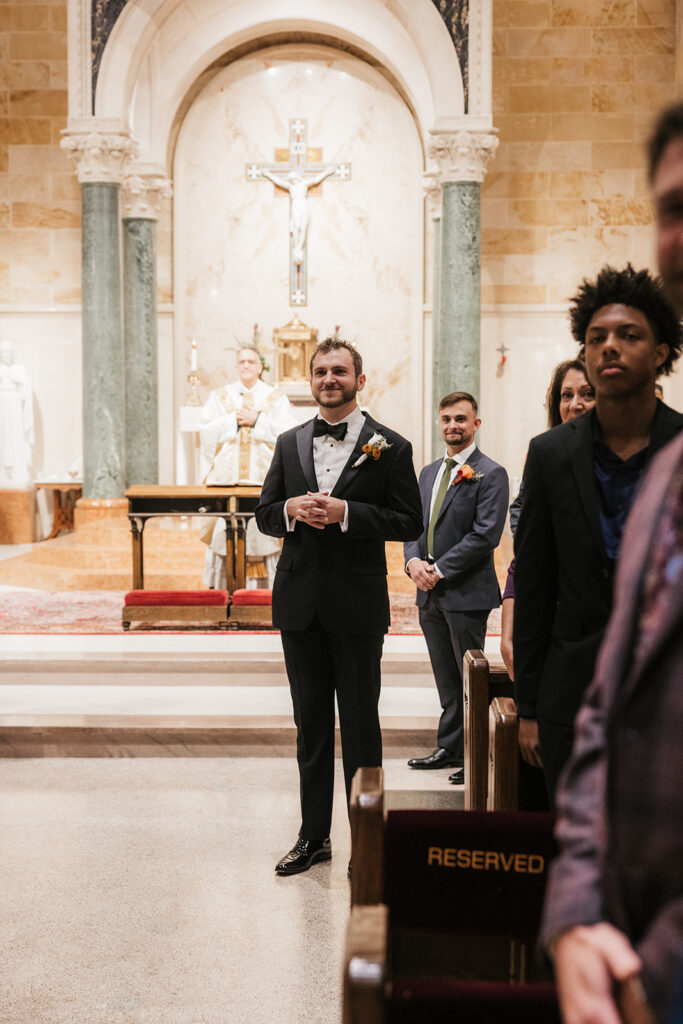 groom emotional watching the bride walk down the aisle