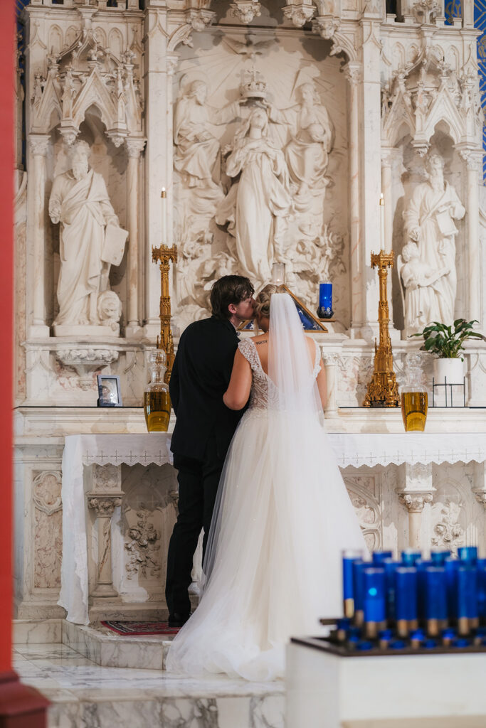 cute picture of the groom kissing the bride on the cheek