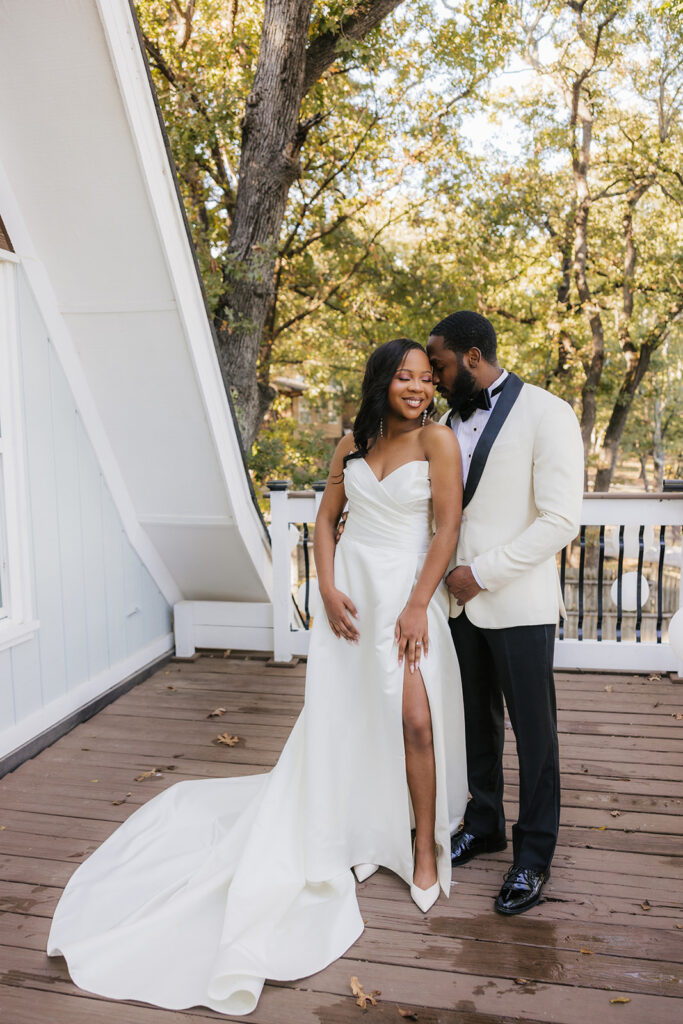 Groom, kissing the bride on the cheek