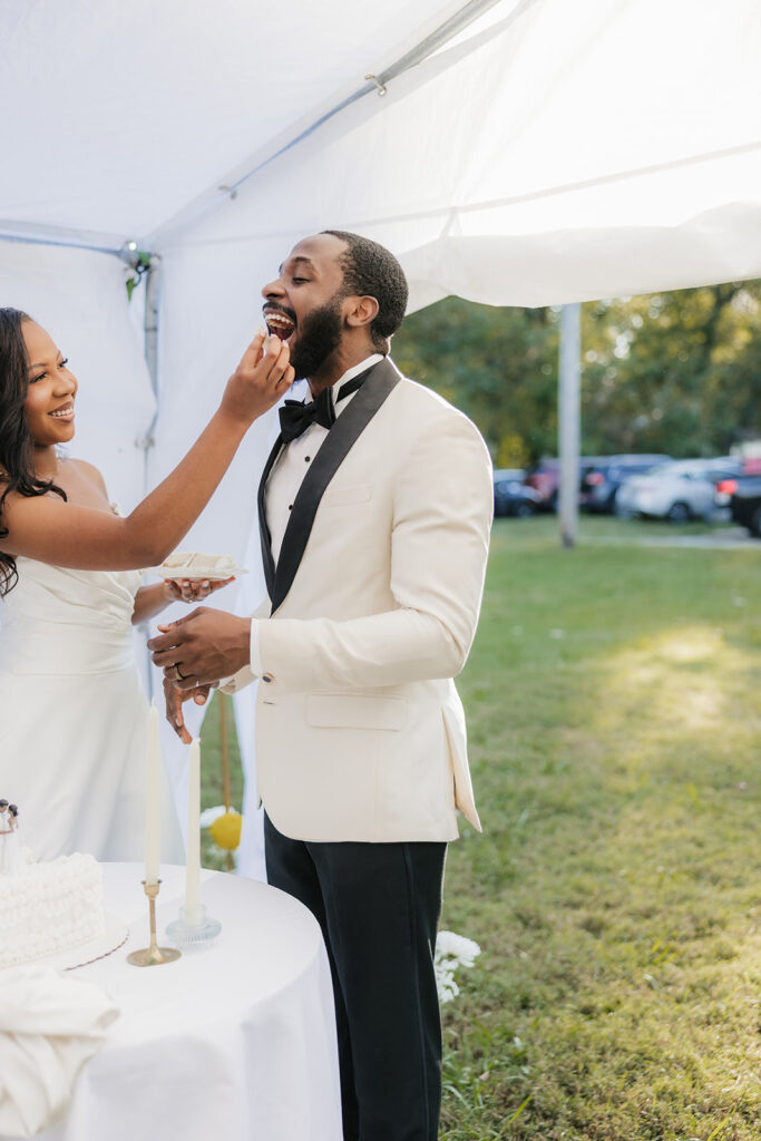 Couple trying their wedding cake