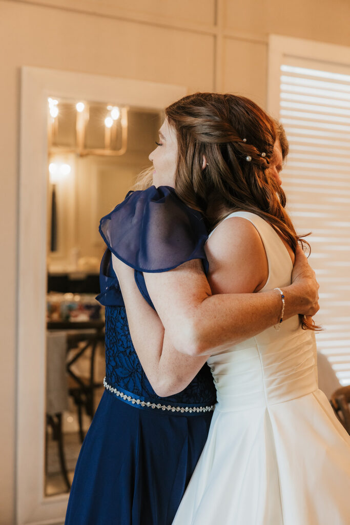 cute picture of the bride and her mom hugging