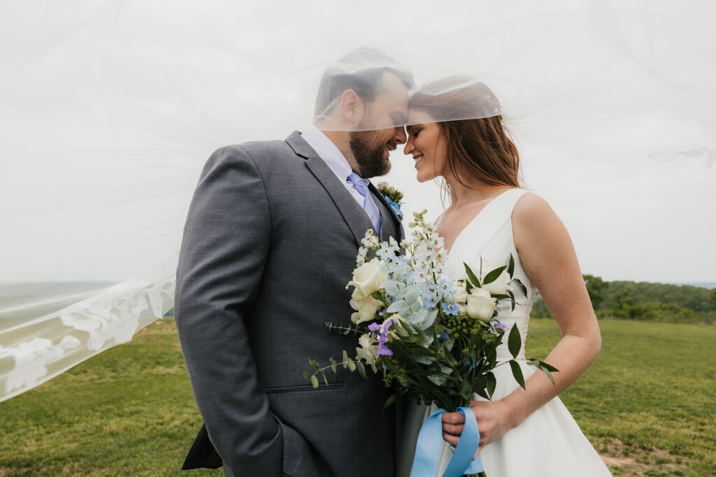 groom kissing the bride on the forehead