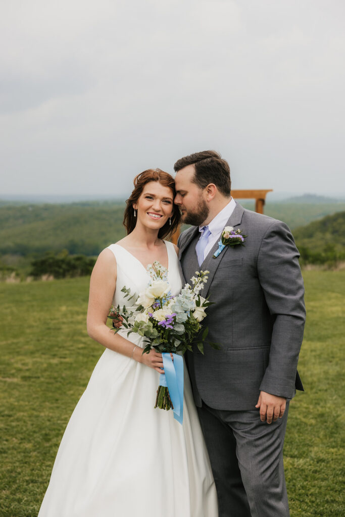 groom kissing the bride on the cheek
