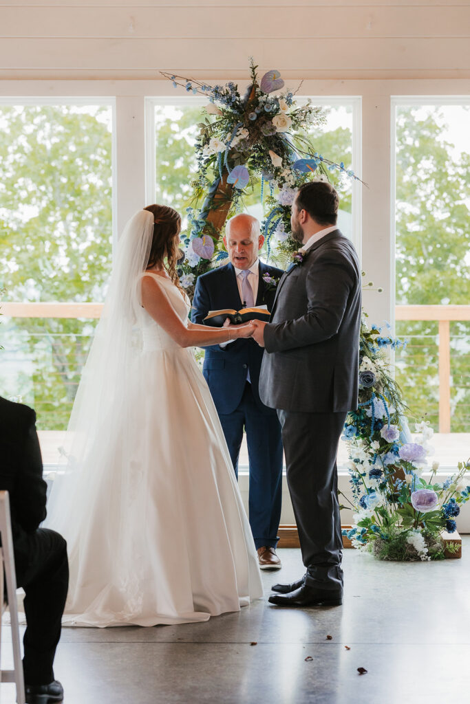 bride and groom holding hands during their ceremony
