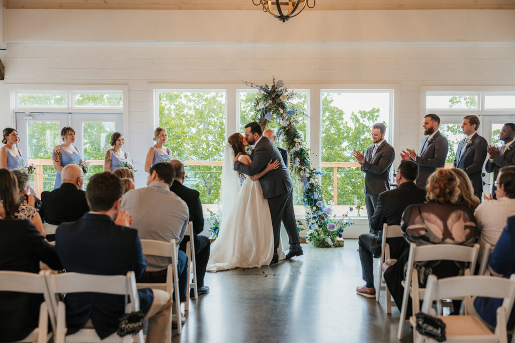 Portrait of the bride and groom, kissing after their ceremony