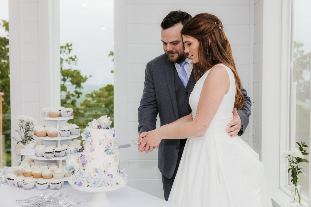 newlyweds cutting their wedding cake