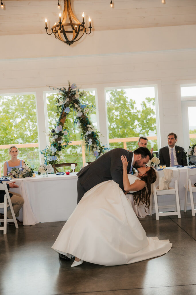 cute picture of the newlyweds kissing at their wedding reception