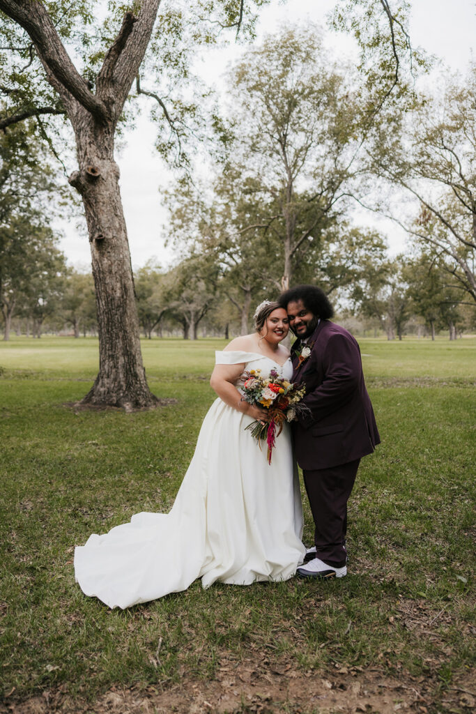 couple smiling at the camera during their photoshoot